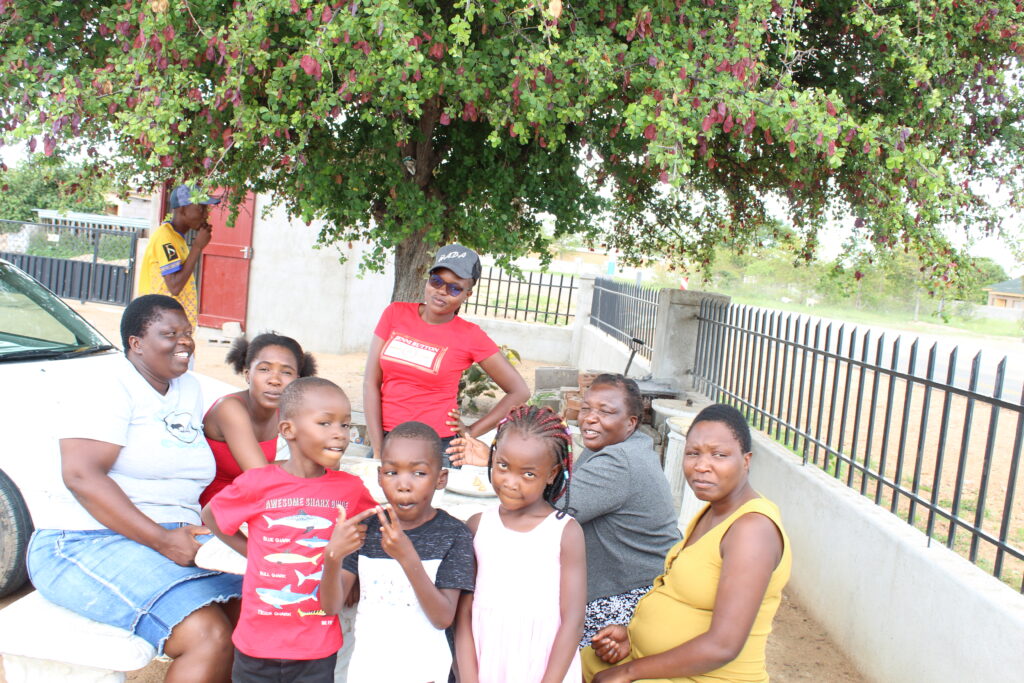 Mehrere Personen sitzen einander zugewandt im Gespräch in einem hellen Zimmer